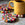 4 multicolor wool coasters on a countertop. A yellow mug is resting on one of the coasters.